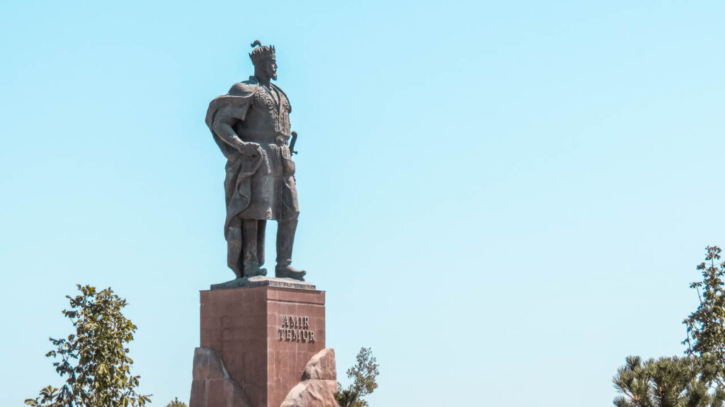 The statue of Amir Timur in Shahrisabz, his hometown. In the background, the palace of Ak-Saray. 